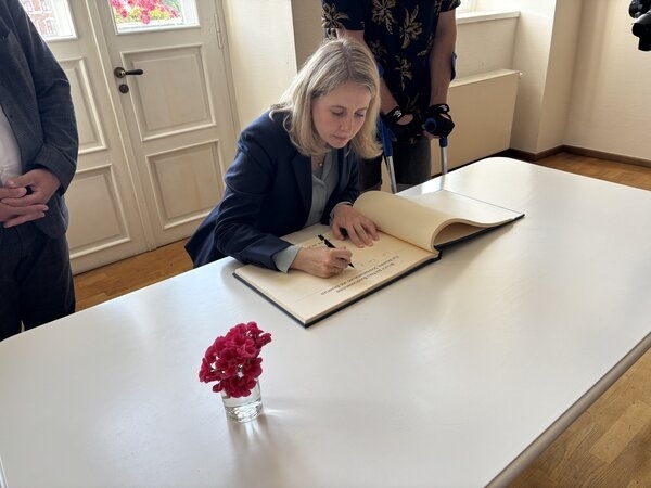 Bild vergr&ouml;&szlig;ern: Bundesministerin Verena Hubertz trägt sich ins Goldene Buch der Hansestadt Wismar ein